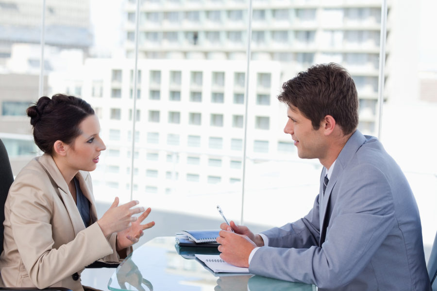 Business pair negotiating in own DISC communication style